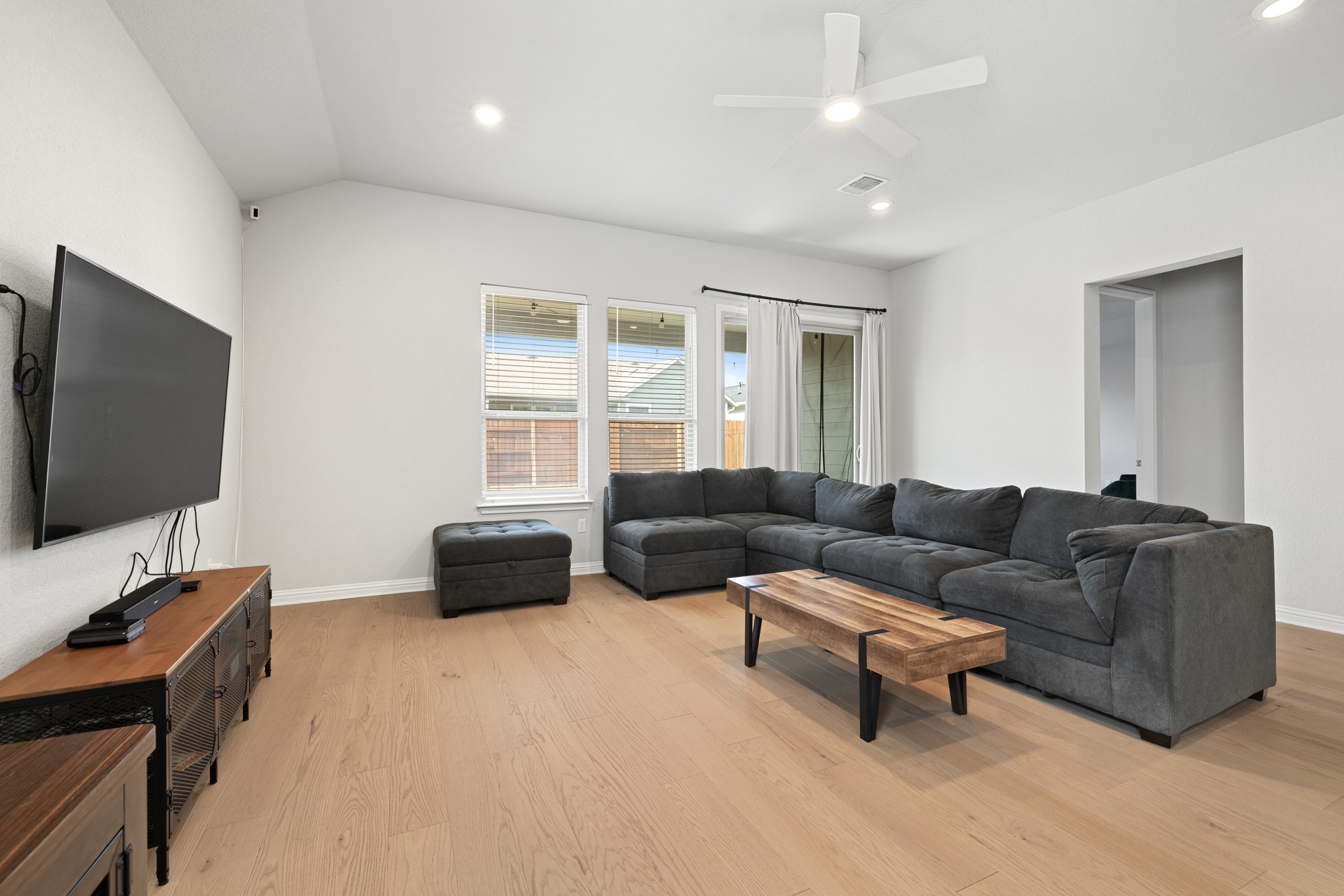 8405 Hubble Walk Austin, TX 78744 - Photo 8 of 36 Living room featuring ceiling fan, light wood-type flooring, recessed lighting, and lofted ceiling