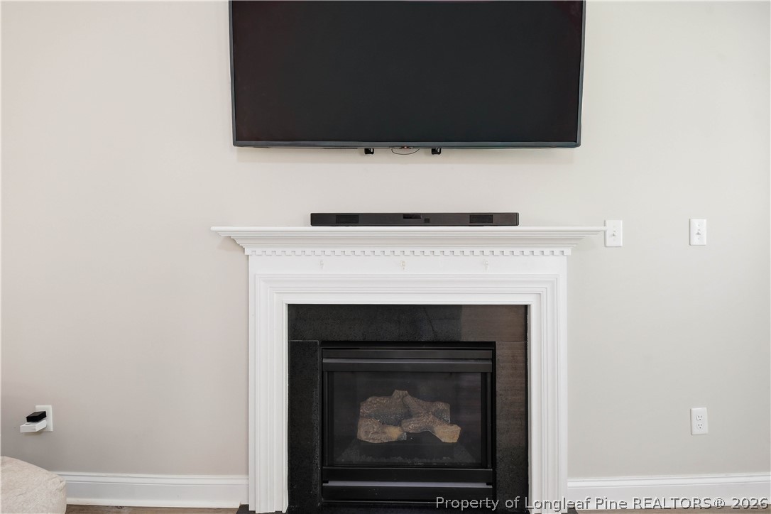 140 Birch Avenue Spring Lake, NC 28390 - Photo 18 of 49 a living room with a fireplace and a flat screen tv
