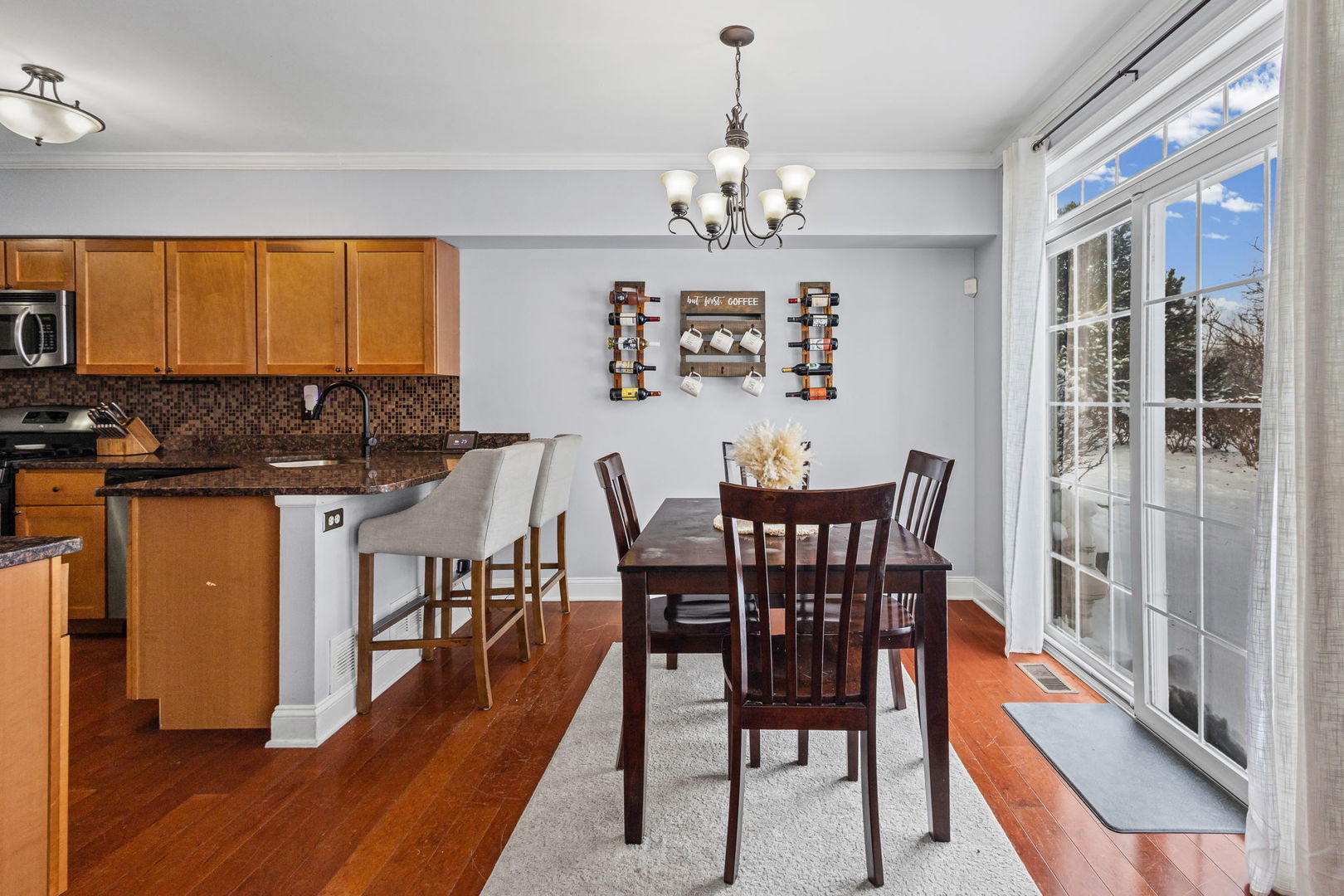 16703 South Sunset Ridge Court Lockport, IL 60441 - Photo 4 of 15 a view of a dining room with furniture a chandelier and wooden floor