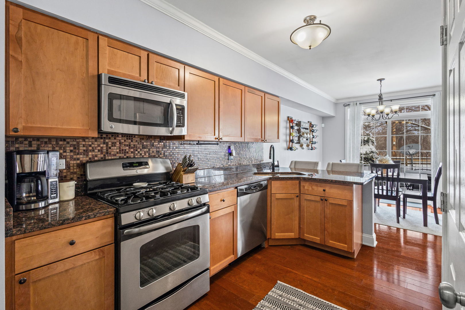 16703 South Sunset Ridge Court Lockport, IL 60441 - Photo 5 of 15 a kitchen with stainless steel appliances granite countertop a stove a sink and a microwave