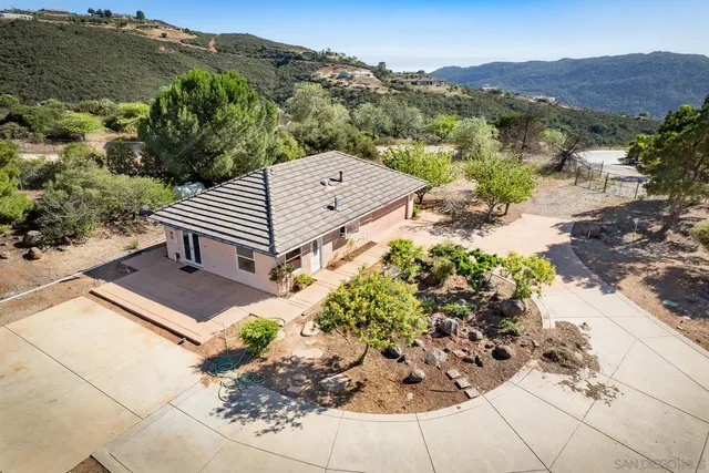 a view of a backyard with sitting area