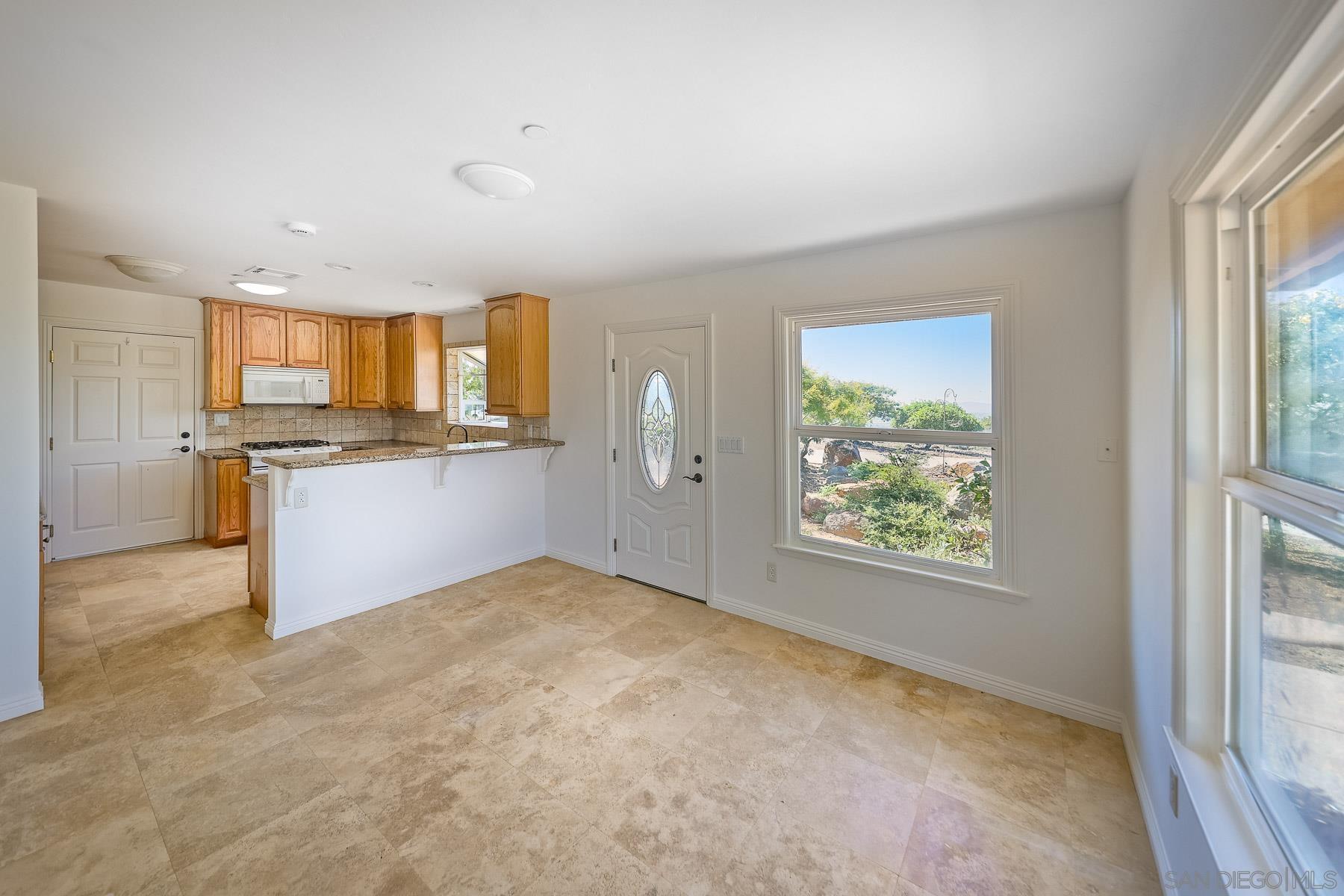 38960 Magee Road Pala, CA 92059 - Photo 5 of 25 a view of a kitchen with microwave and windows