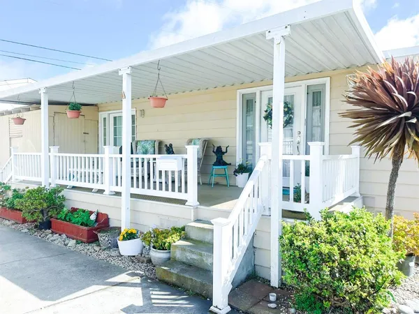 a front view of a house with a garden