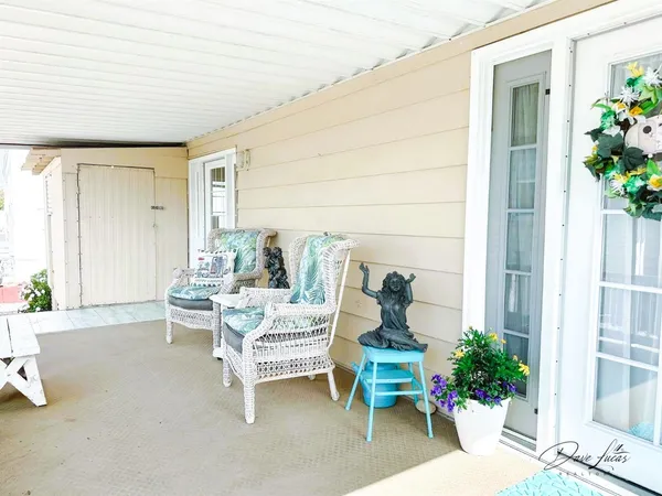 a balcony with furniture and flowers