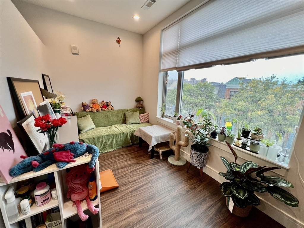 99 Sumner Street, Unit 307 Boston, MA 02128 - Photo 16 of 18 a living room with furniture and wooden floor