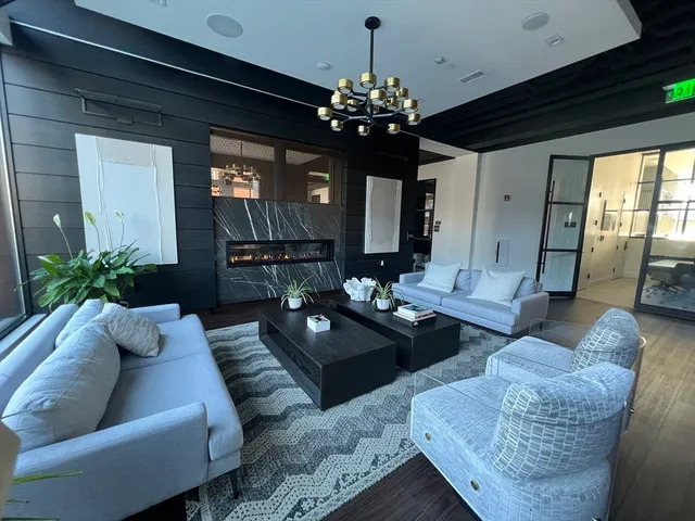 a room with table or chairs and a chandelier