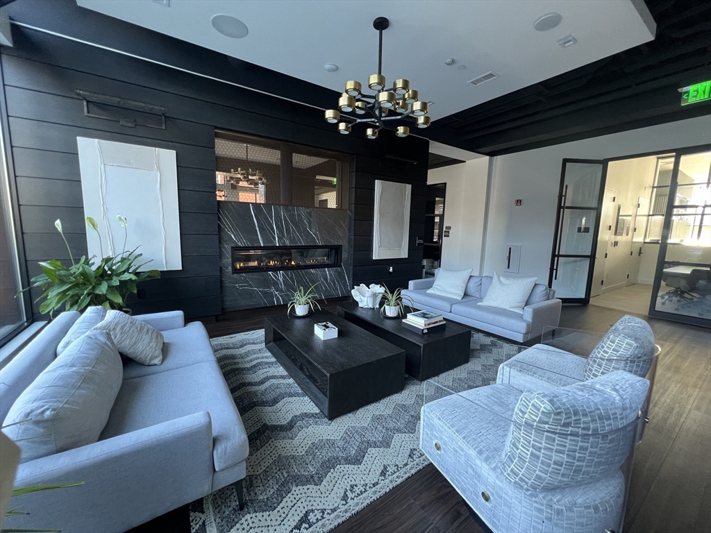 99 Sumner Street, Unit 307 Boston, MA 02128 - Photo 3 of 18 a living room with furniture and a large window