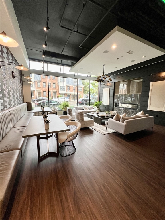 99 Sumner Street, Unit 307 Boston, MA 02128 - Photo 6 of 18 a living room with furniture and a large window