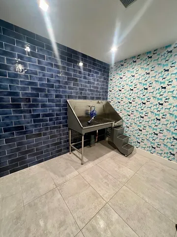 a kitchen with a sink cabinets and wooden floor