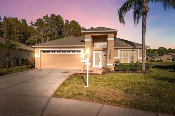a front view of a house with a yard and garage