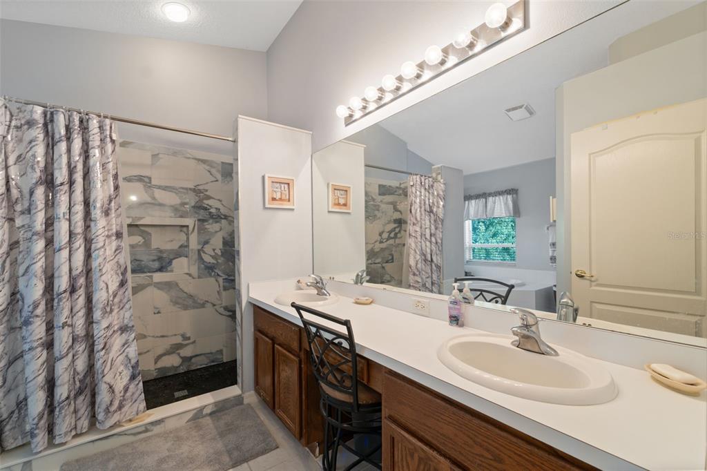 1201 Dustan Place Trinity, FL 34655 - Photo 26 of 78 a bathroom with a double vanity sink mirror and shower