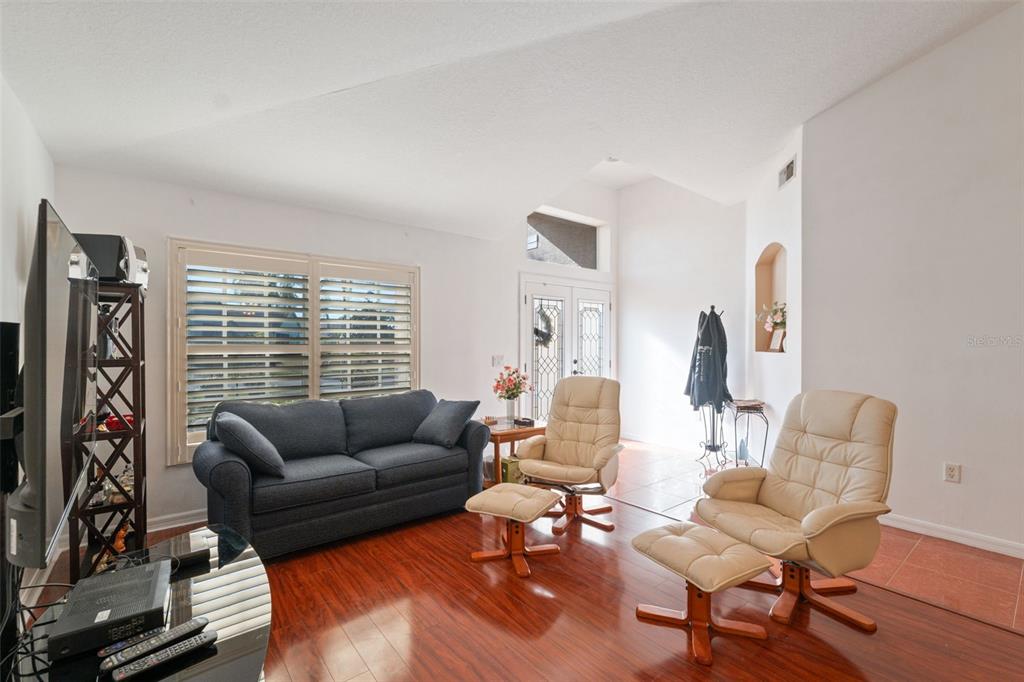 1201 Dustan Place Trinity, FL 34655 - Photo 7 of 78 a living room with furniture and a large window
