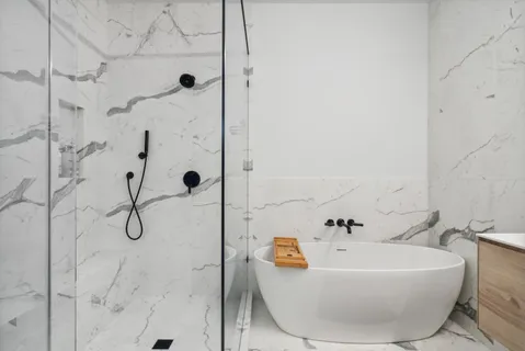 a white bath tub sitting in a bathroom