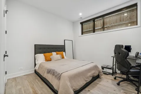 a bedroom with a bed a desk and chair