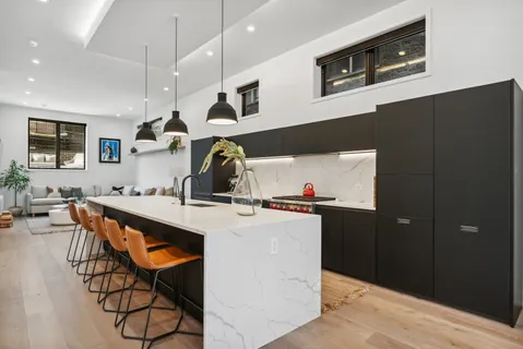 a kitchen with stainless steel appliances granite countertop a sink and a stove