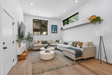 a living room with furniture and a potted plant