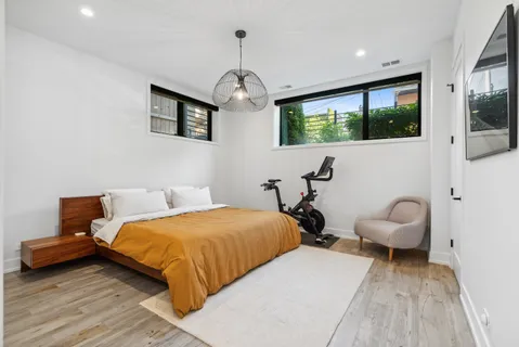 a bedroom with a bed and a chair