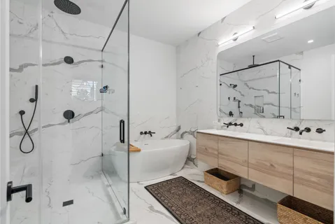 a bathroom with a sink double vanity and shower