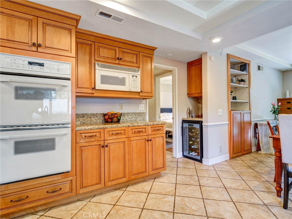 19238 Castlebay Lane Porter Ranch, CA 91326 - Photo 12 of 38 a kitchen with stainless steel appliances granite countertop a refrigerator and a stove top oven