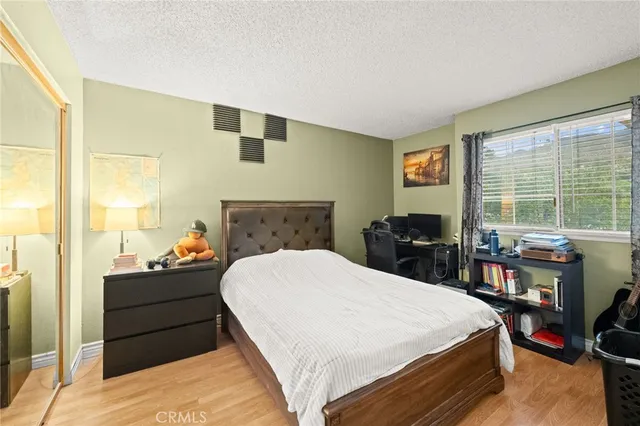 a bedroom with a bed and a large window