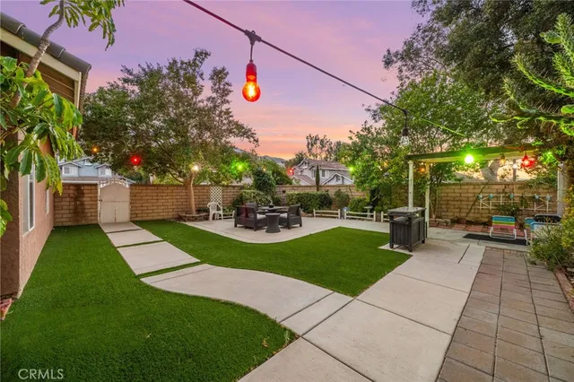 a view of backyard with seating area and green space