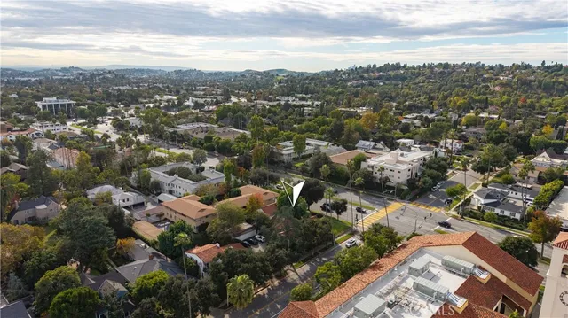 an aerial view of residential houses with city view