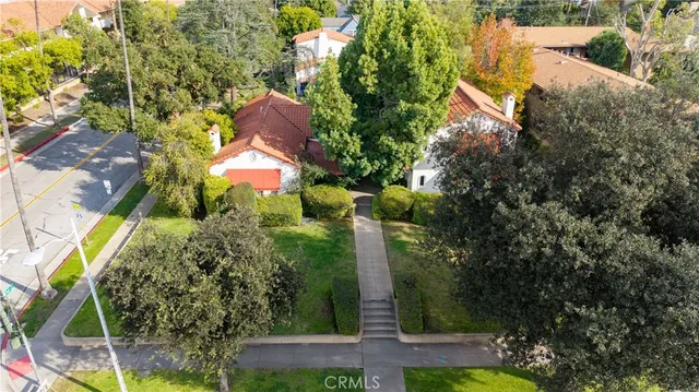 an aerial view of a house with a yard basket ball court and outdoor seating