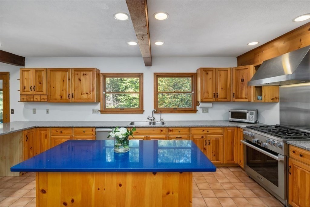 58 High Street Medfield, MA 02052 - Photo 3 of 41 a kitchen with stainless steel appliances a sink a stove a refrigerator cabinets and a window