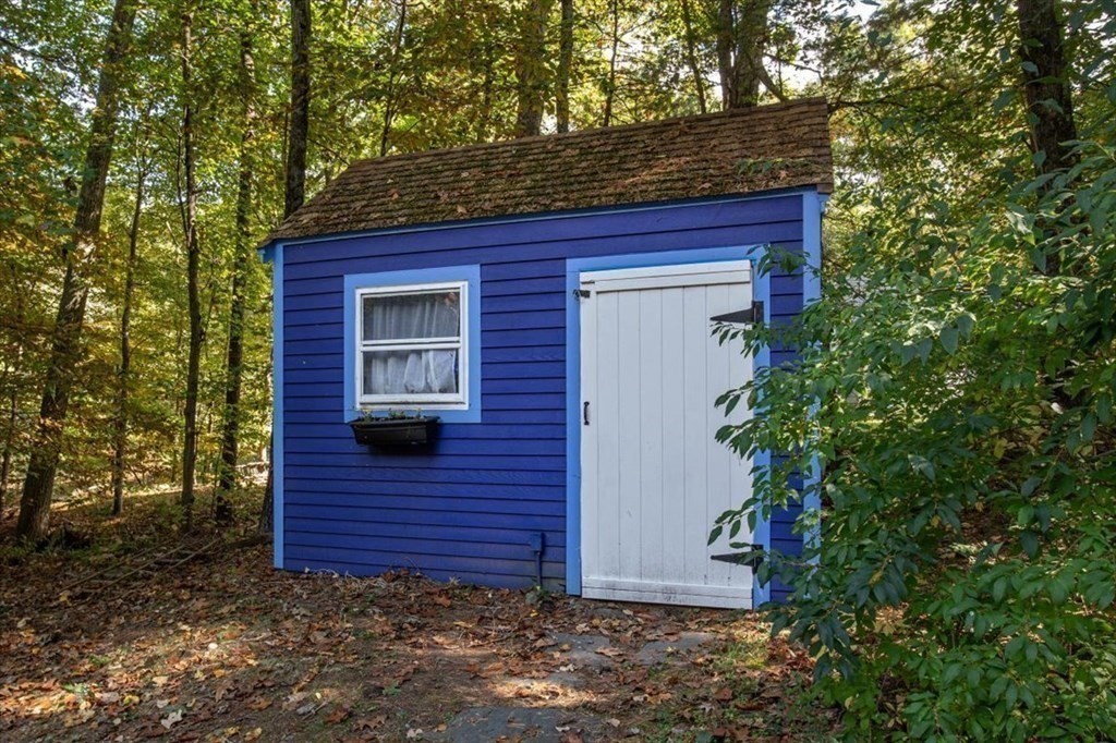 58 High Street Medfield, MA 02052 - Photo 38 of 41 a view of a brick house with large windows and a yard