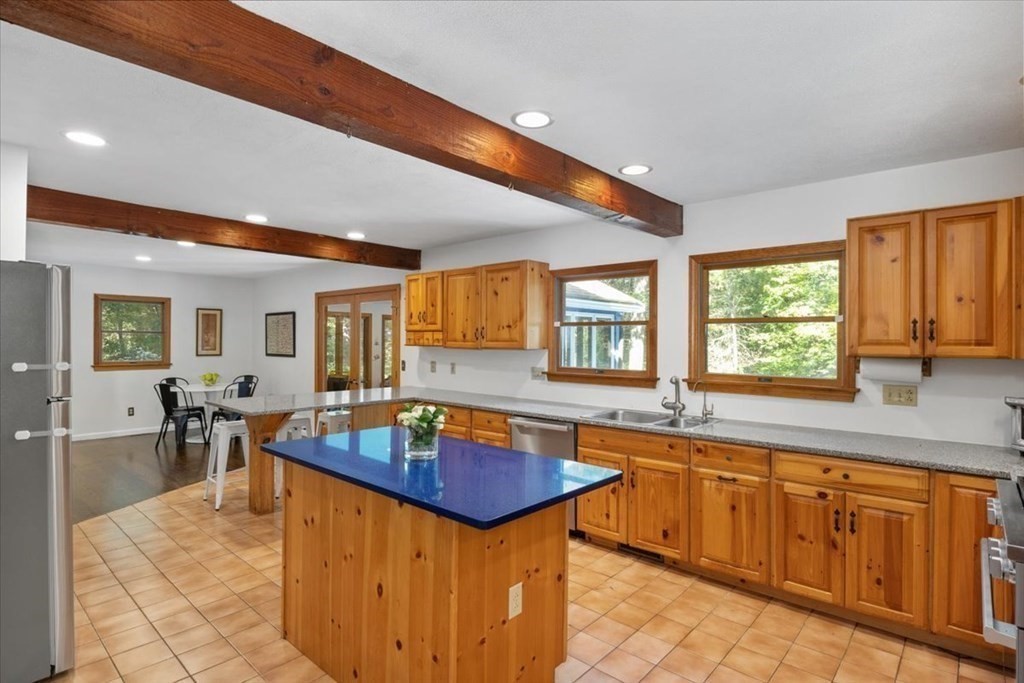 58 High Street Medfield, MA 02052 - Photo 4 of 41 a dining hall with stainless steel appliances granite countertop a sink dishwasher and cabinets with wooden floor