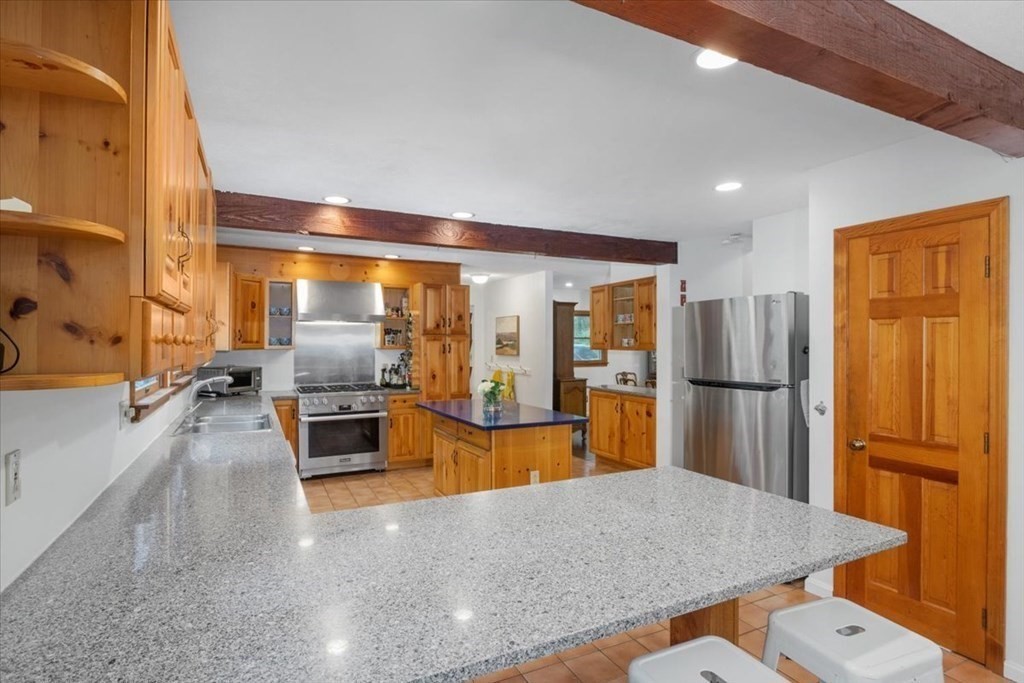 58 High Street Medfield, MA 02052 - Photo 5 of 41 a large kitchen with stainless steel appliances a refrigerator and microwave