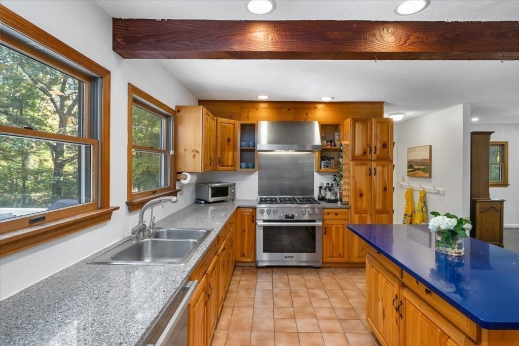 58 High Street Medfield, MA 02052 - Photo 6 of 41 a kitchen with stainless steel appliances granite countertop a sink stove and refrigerator