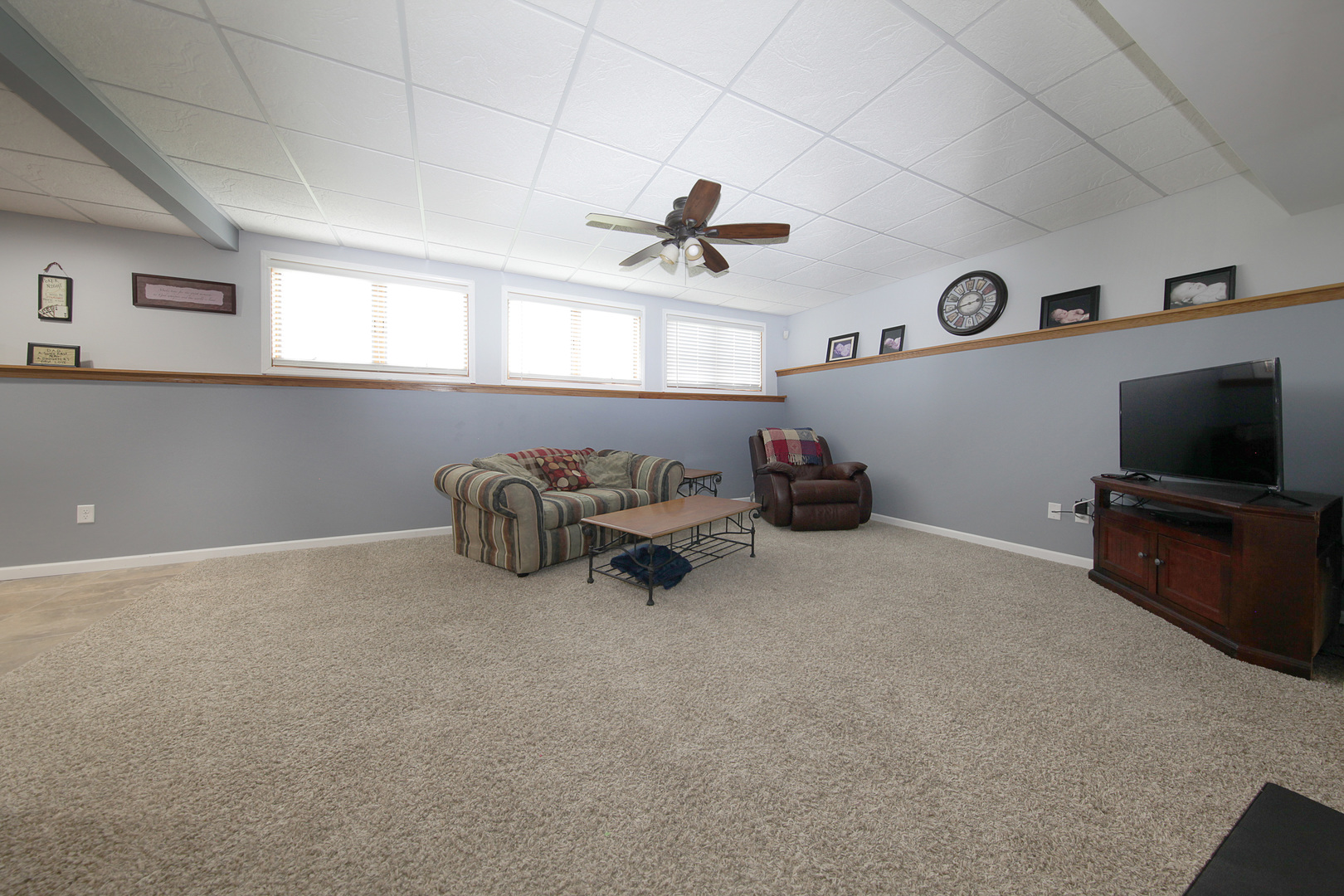 4420 West Shabbona Road Morris, IL 60450 - Photo 23 of 31 a living room with furniture a flat screen tv and gym equipment