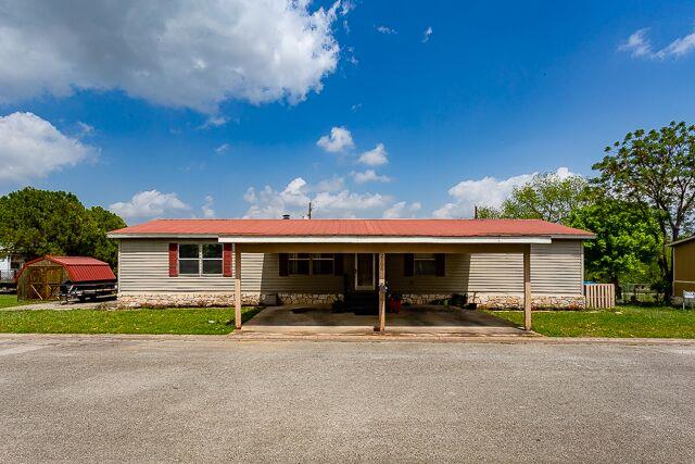 a view of house with a yard in front of it