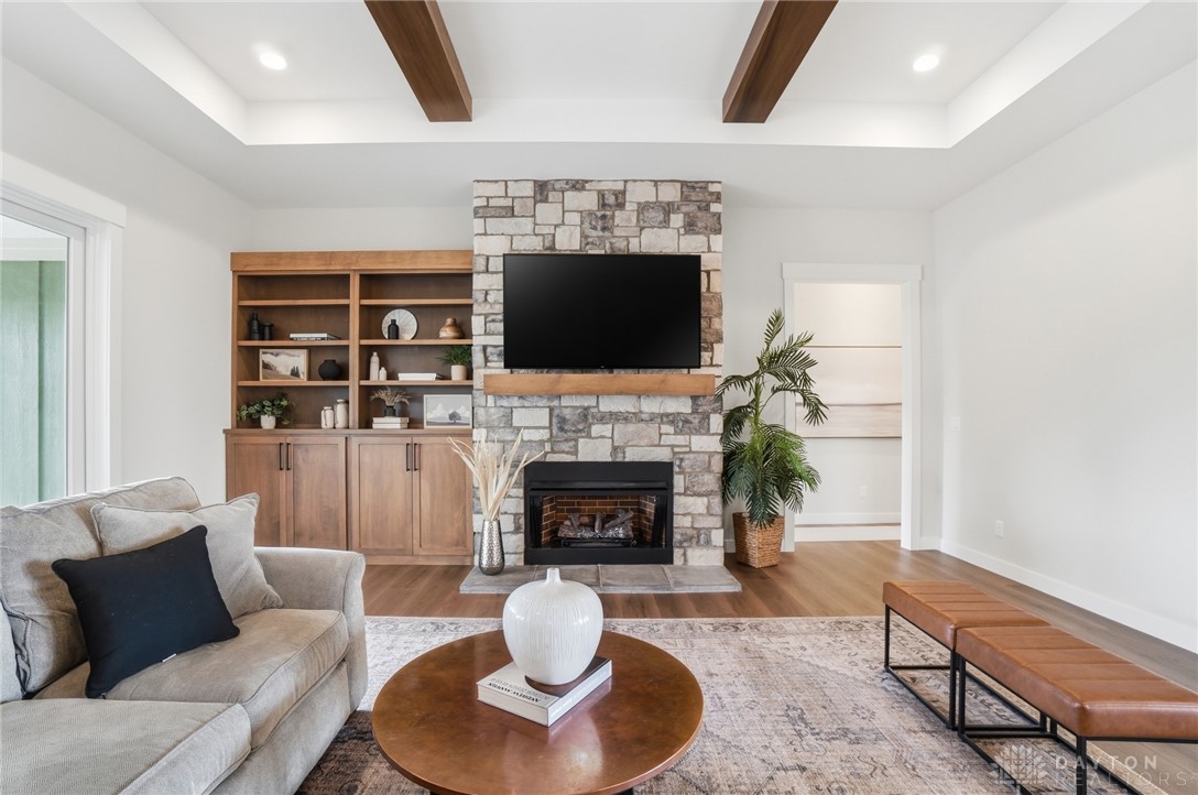 9364 Kenrick Road Dayton, OH 45458 - Photo 9 of 62 This inviting living space features warm wood tones and a prominent stone fireplace, perfect for relaxation.