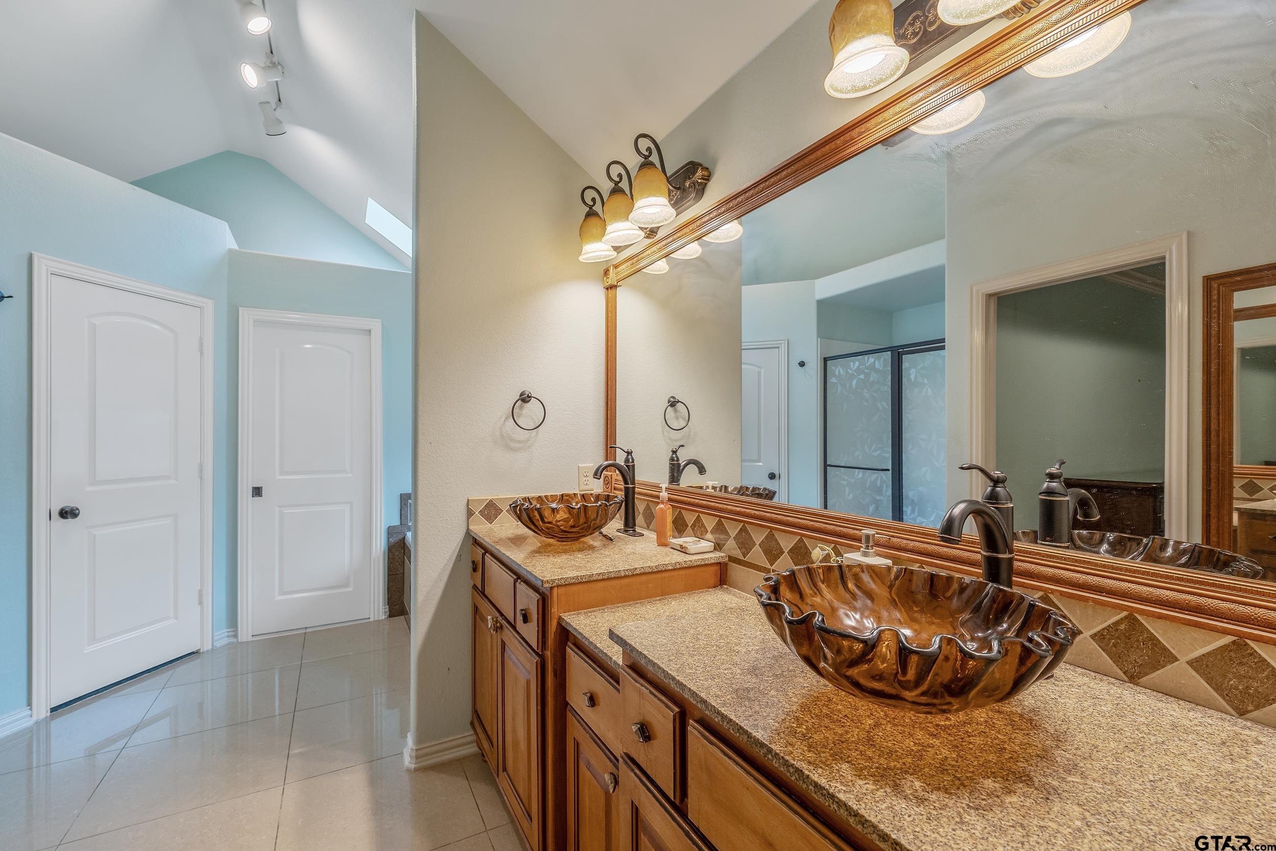 3072 Yasmeen Circle Flint, TX 75762 - Photo 12 of 26 a bathroom with a sink double vanity and a mirror