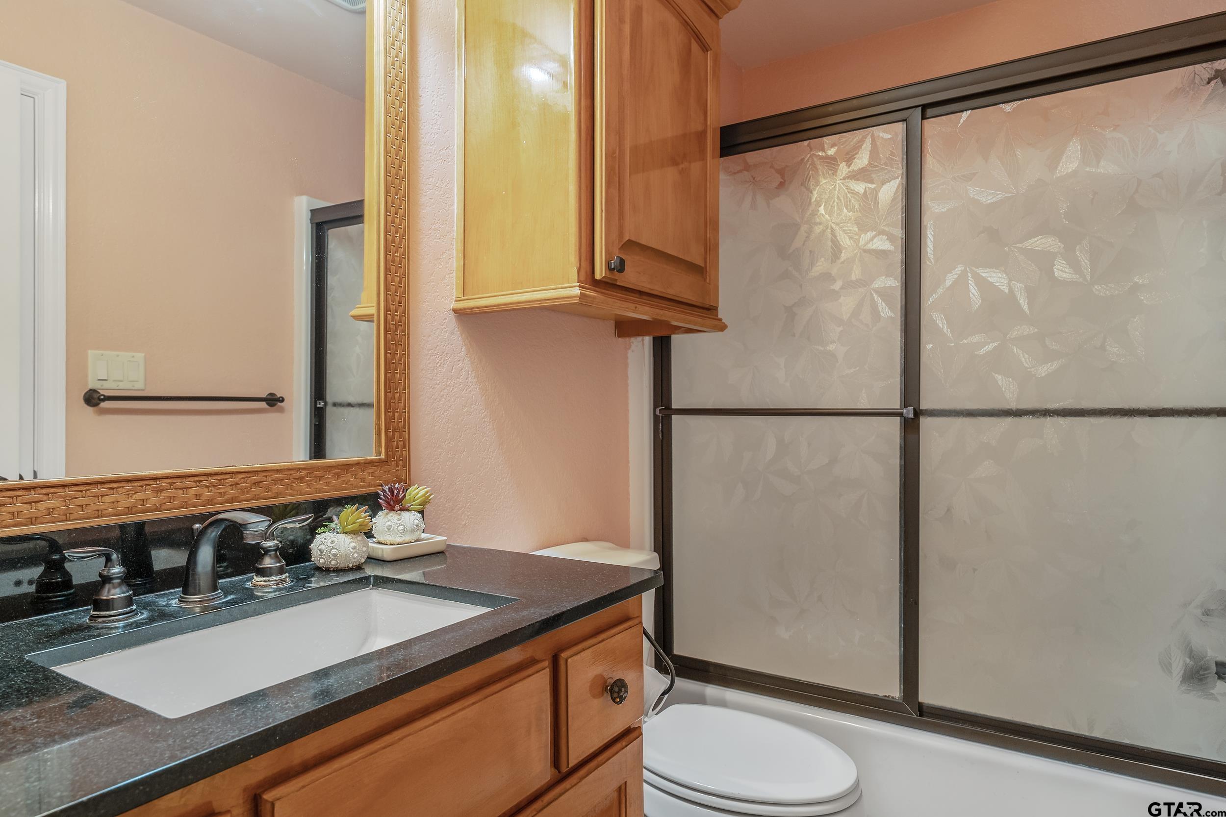 3072 Yasmeen Circle Flint, TX 75762 - Photo 16 of 26 a bathroom with a sink and a mirror