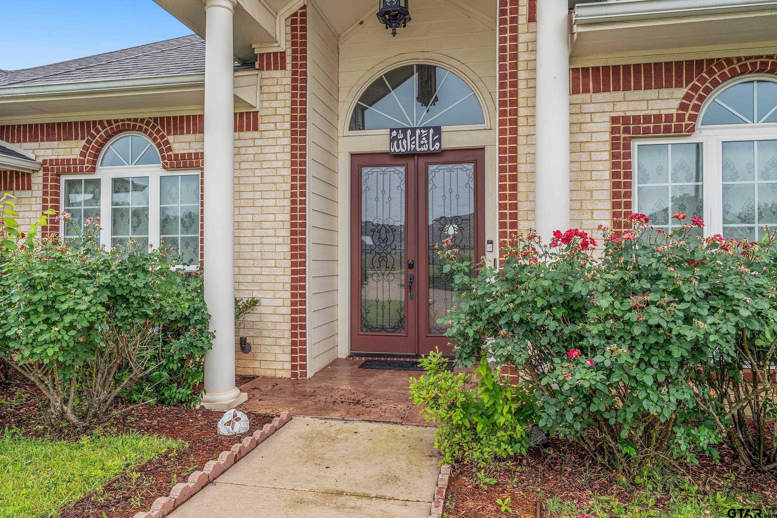 3072 Yasmeen Circle Flint, TX 75762 - Photo 2 of 26 front view of a brick house with a small yard