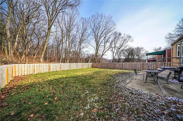 a view of backyard with seating and green space
