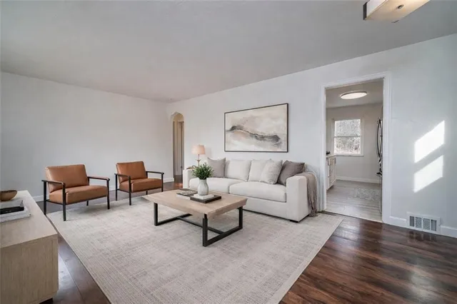 a living room with furniture and a potted plant on table