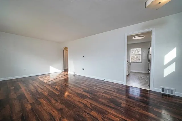 a view of a livingroom with wooden floor and window