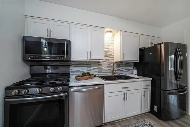 a kitchen with a stove microwave and refrigerator