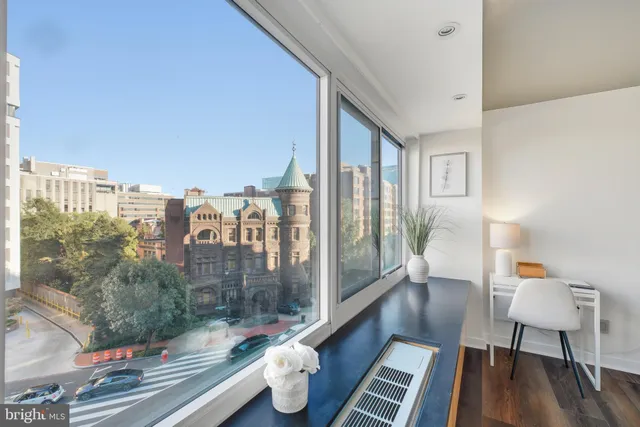 a living room with couch and a wooden floor