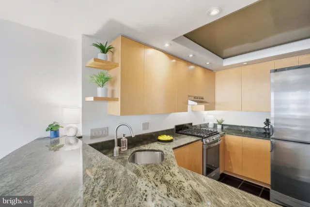 a kitchen with a sink stove and a refrigerator