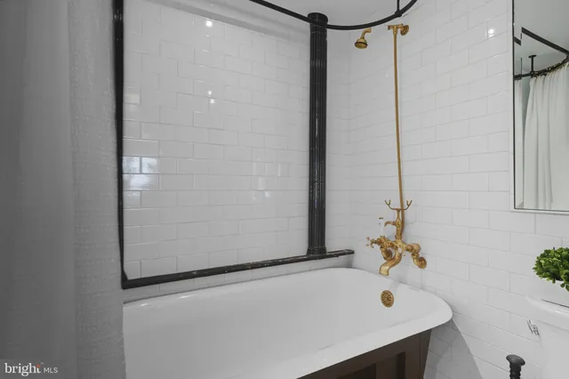 a bathroom with a tub and a sink