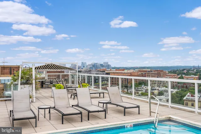 a view of a chairs and table in patio with a lake view