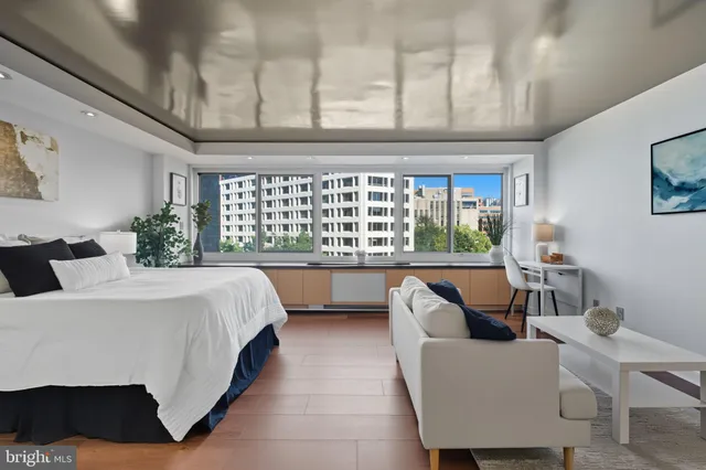 a bedroom with a large bed and a window