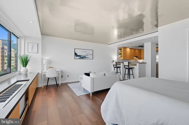 a bedroom with wooden floor and furniture