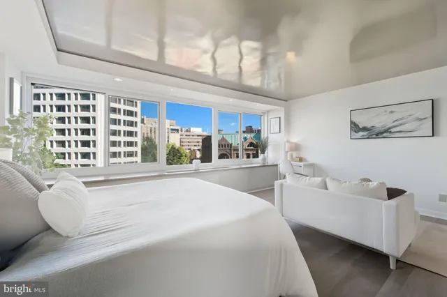 a spacious bedroom with a large bed and a large window