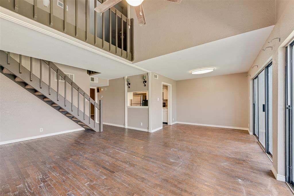 a view of an entryway wooden floor and staircase
